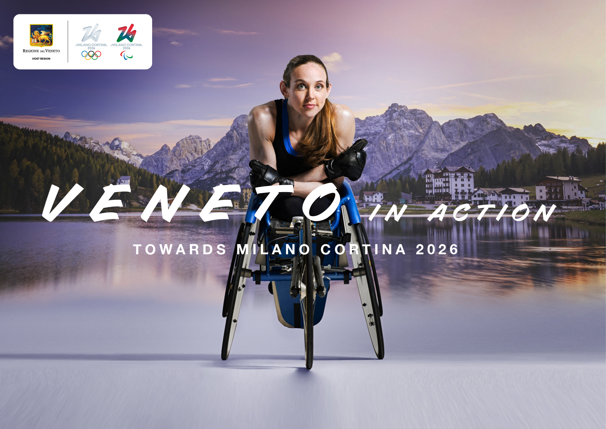 atleta paralimpica in carrozzina con lago e montagne sullo sfondo con scritta 